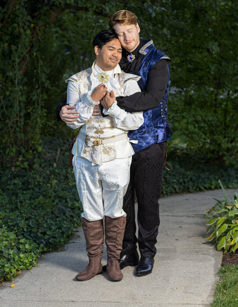 Gay wedding couple in Renaissance-inspired attire posing for romantic wedding portraits at Aberdeen Manor in Valparaiso, Indiana