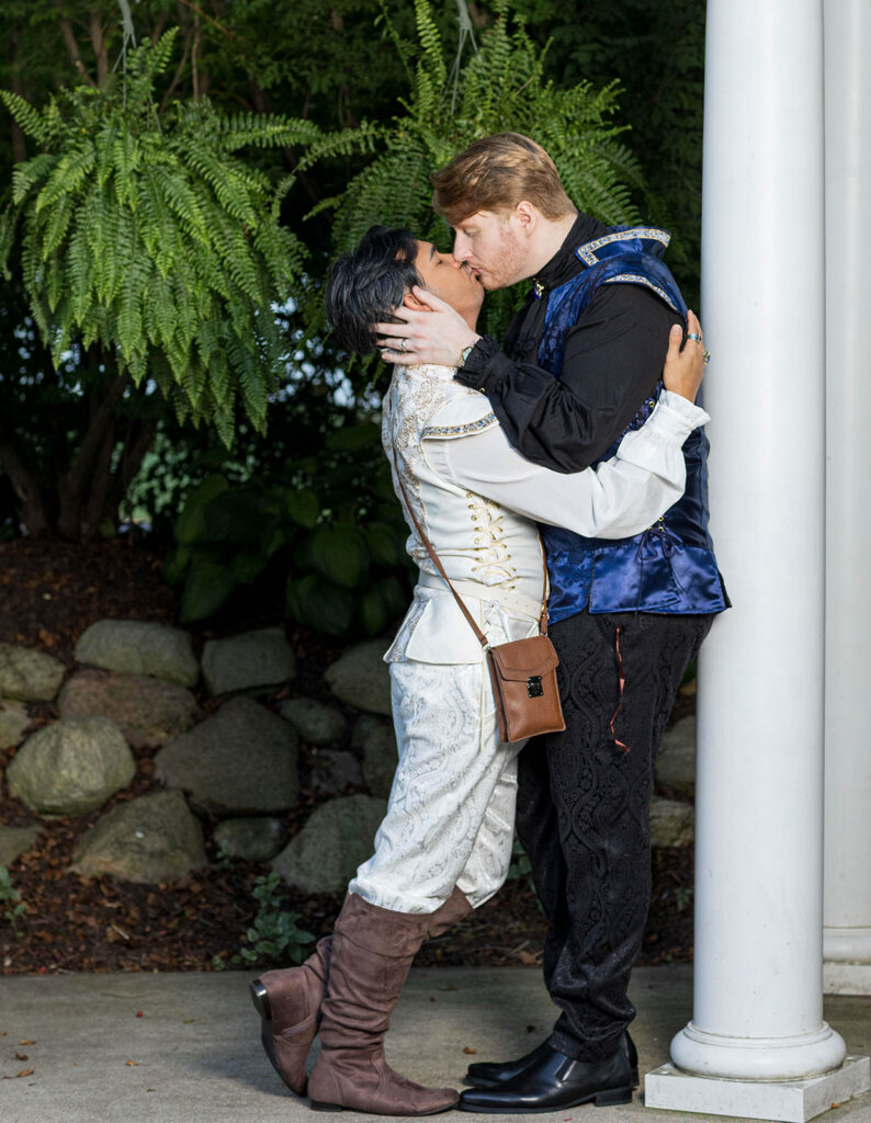Gay wedding couple in Renaissance-inspired attire posing for romantic wedding portraits at Aberdeen Manor in Valparaiso, Indiana