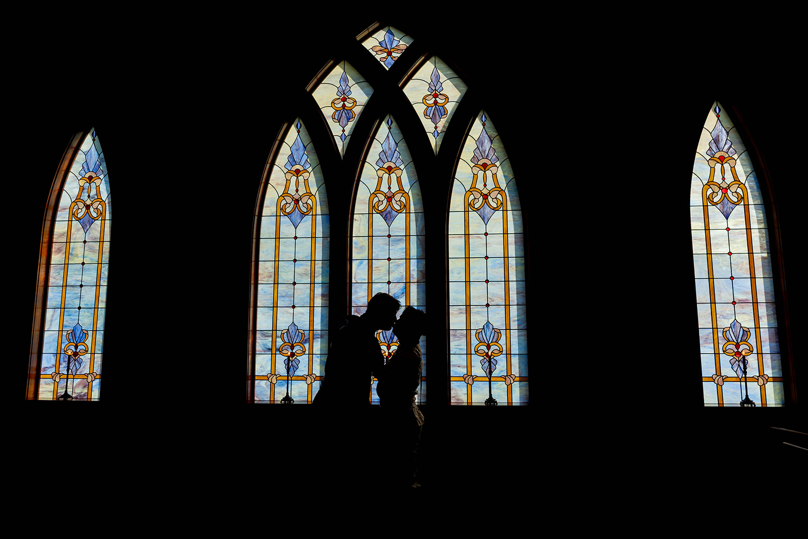 Gay wedding couple in Renaissance-inspired attire posing for romantic wedding portraits at Aberdeen Manor in Valparaiso, Indiana
