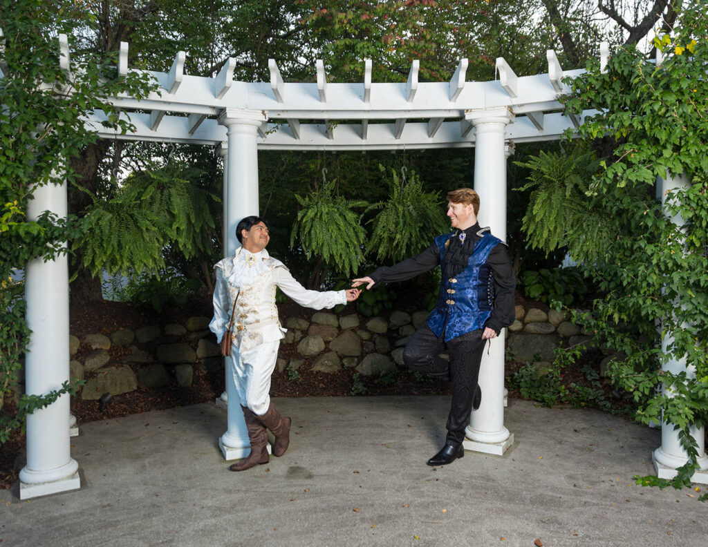 Gay wedding couple in Renaissance-inspired attire posing for romantic wedding portraits at Aberdeen Manor in Valparaiso, Indiana