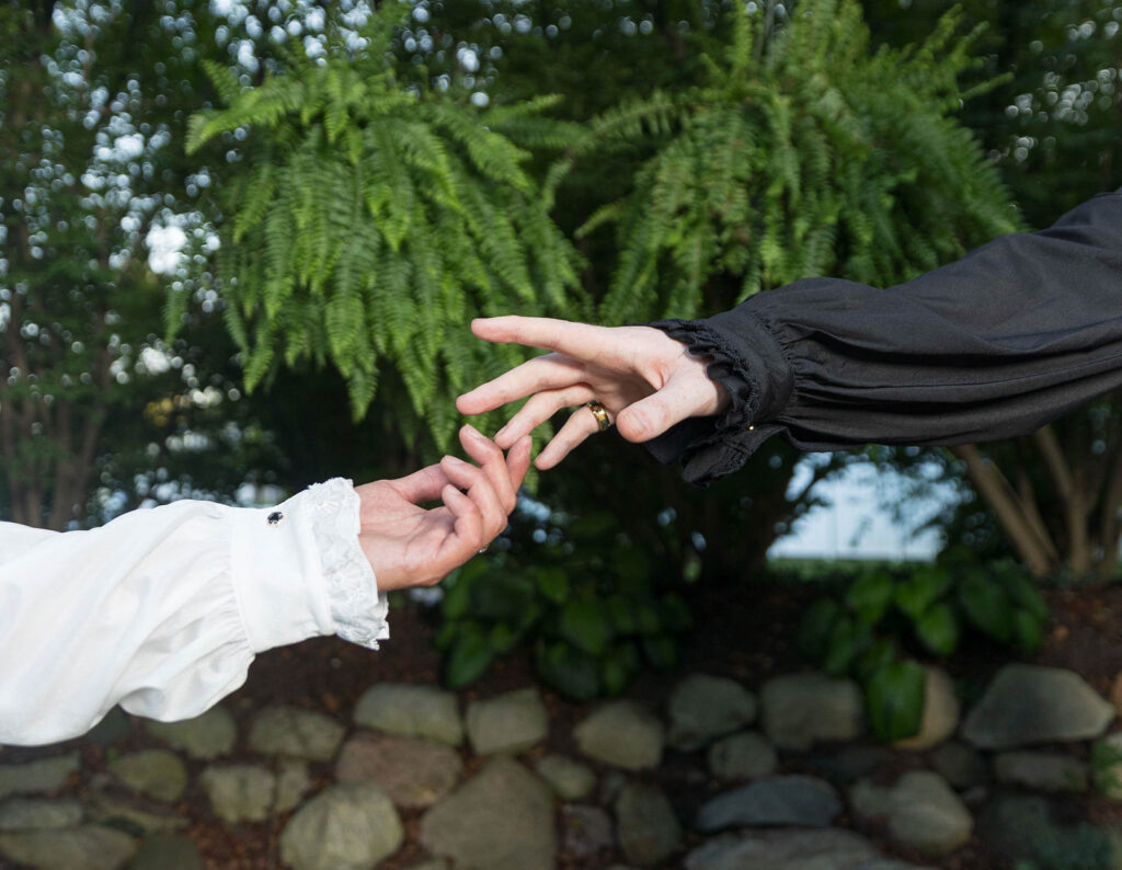 Gay wedding couple in Renaissance-inspired attire posing for romantic wedding portraits at Aberdeen Manor in Valparaiso, Indiana